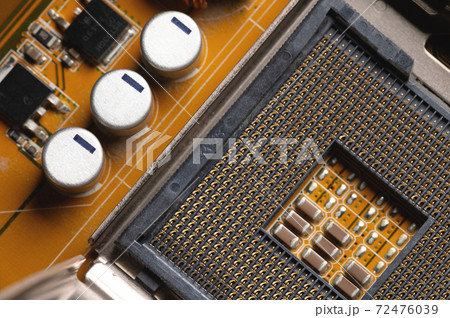 Blank cpu cpu socket with pins on motherboard in yellow color close-up 72476039