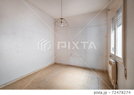 Empty, old and dirty room with white walls and traces of shelves 72478274