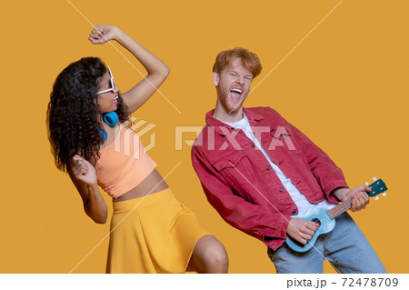 Good-looking young couple having fun and dancing Good-looking young couple having fun and dancing 72478709