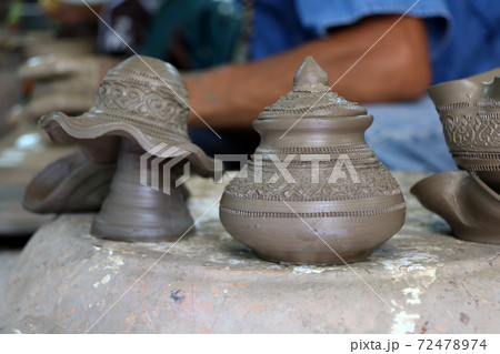 Small raw pottery before burn in the kiln, at Kret Island in Nonthaburi Thailand. Small raw pottery before burn in the kiln, at Kret Island in Nonthaburi Thailand. 72478974