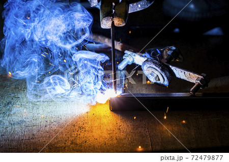 Professional welder man working on metal welding and sparks metal. Professional welder man working on metal welding and sparks metal. 72479877