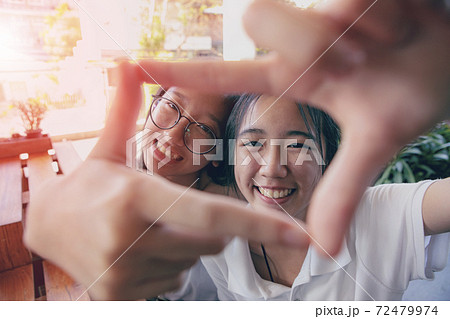 two asian teenager toothy smiling face with happiness mood two asian teenager toothy smiling face with happiness mood 72479974