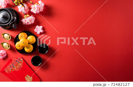 Chinese new year festival decorations pow or red packet, orange and gold ingots or golden lump on a red background. Chinese characters FU in the article refer to fortune good luck, wealth, money flow. 72482127