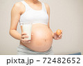 Young woman asian choose eating healthy food,eggs and milk during her pregnancy 72482652