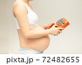 A pregnant woman plays a kalimba instrument for her unborn child to listen. Music is something that will help your baby's brain development 72482655