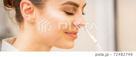 Woman receiving essential oil inhaler 72482749