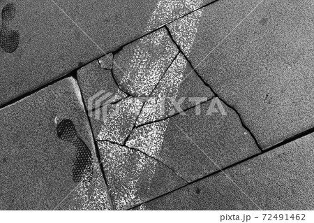 Urban road surface with cracks and road marking line 72491462