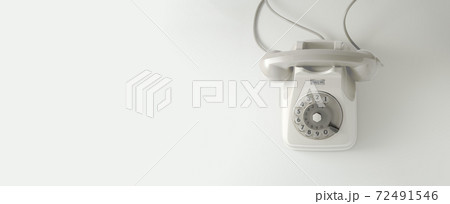 A white vintage dial telephone. 72491546