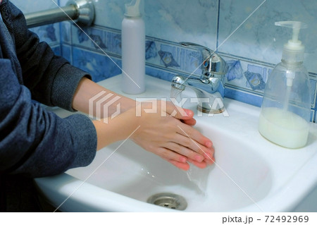 Child boy washing hands with antibacterial soap in sink against coronavirus. Child boy washing hands with antibacterial soap in sink against coronavirus. 72492969