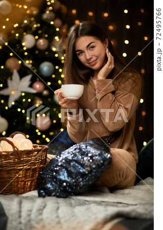 smiling young woman is holding cup of coffee smiling young woman is holding cup of coffee 72495766