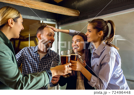 Happy co-workers celebrating corporate event after tensioned work day. Look delighted, friendly, cheerful Happy co-workers celebrating corporate event after tensioned work day. Look delighted, friendly, cheerful 72496448