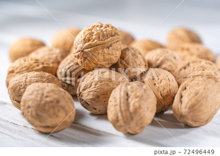 Walnuts kernels on white wooden desk, stock photo Walnuts kernels on white wooden desk, stock photo 72496449