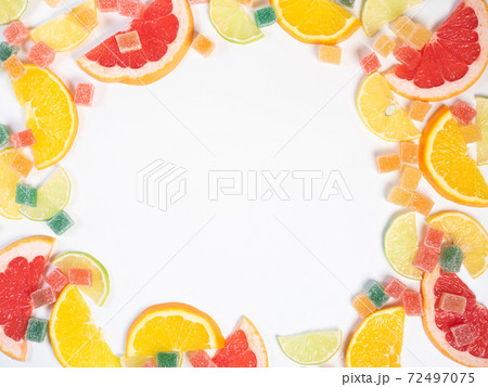 Frame of fruits and marmalade jelly candies on white Frame of fruits and marmalade jelly candies on white 72497075