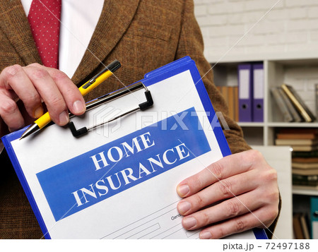 Papers about Home insurance claim and pen for filling out. 72497188
