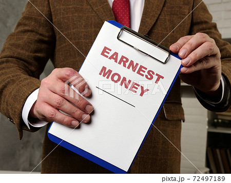 The clerk in the room introduces the earnest money documents. 72497189