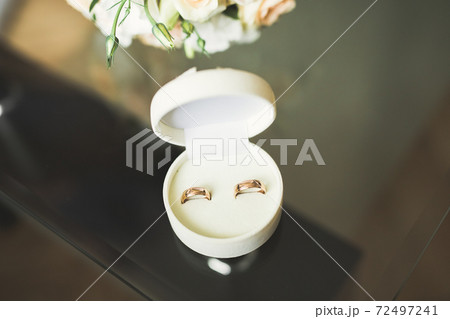 Two golden wedding rings isolated background concept 72497241