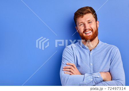 cheerful caucasian guy in blue stylish shirt smiles at camera isolated 72497314