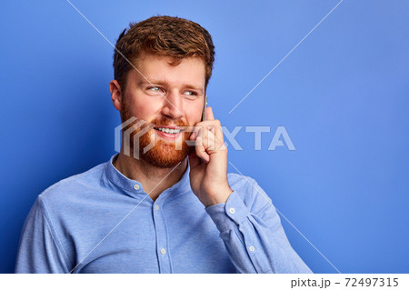 optimistic caucasian male talk on phone with someone 72497315