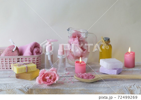 Fresh pink roses, water, petals, candles on a light background, body care products, natural home cosmetics, healthy lifestyle, alternative medicine Fresh pink roses, water, petals, candles on a light background, body care products, natural home cosmetics, healthy lifestyle, alternative medicine 72499269