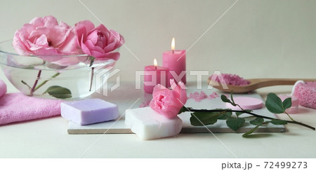 Fresh pink roses, water, petals, candles on a light background, body care products, natural home cosmetics, healthy lifestyle, alternative medicine 72499273