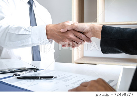 Greeting new colleagues, Handshake while job interviewing, male candidate shaking hands with Interviewer or employer after a job interview, employment and recruitment concept 72499877
