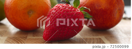 Kitchen table with fresh strawberry and orange fruits Kitchen table with fresh strawberry and orange fruits 72500099
