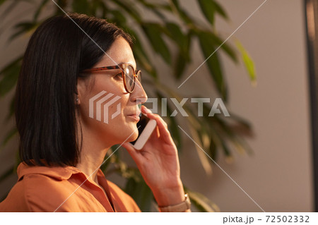 Contemporary Businesswoman Speaking by Smartphone Side View 72502332