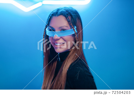Young woman smiling in futuristic glasses. New noir Young woman smiling in futuristic glasses. New noir 72504203