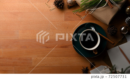 Wooden table with copy space, coffee cup and decorations in Christmas concept 72507731