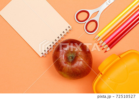 Notebook, apple, scissors, color pencils and lunch box. School supplies. Notebook, apple, scissors, color pencils and lunch box. School supplies. 72510527