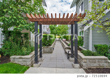 Walkway in residential area between two rows of townhouses with unit for sale Walkway in residential area between two rows of townhouses with unit for sale 72510694