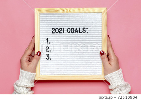female hands holds felt board with text - 2021 goals on pink background Planning, self motivation, achievement, success, wish list, checklist concept Top view Flat lay Motivational quote, message female hands holds felt board with text - 2021 goals on pink background Planning, self motivation, achievement, success, wish list, checklist concept Top view Flat lay Motivational quote, message 72510904