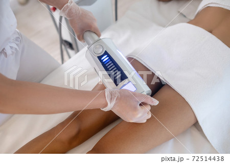 Doctors hands with working apparatus for body correction. 72514438