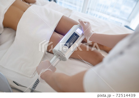 Doctors hands with apparatus performing the procedure 72514439