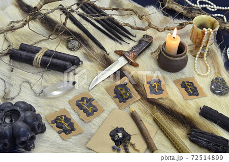 Still life with runes, ritual knife and black candles on witch table. Esoteric, gothic and occult background, Halloween mystic concept. Still life with runes, ritual knife and black candles on witch table. Esoteric, gothic and occult background, Halloween mystic concept. 72514899