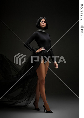 sexy brunette woman in long black dress 72516928