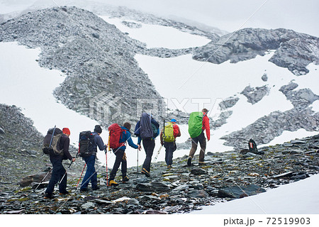 Team of travelers hiking in mountains. Team of travelers hiking in mountains. 72519903