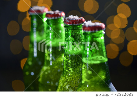 Green Bottle Of Beer and Holiday Glitter Background 72522035