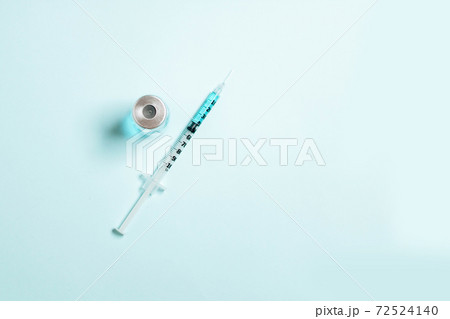 Syringes with blue medicine liquid on an isolated blue solid background. Vaccination, immunity, cosmetology concept 72524140