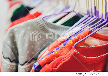 Colorful collection of women's clothes hanging on a rack. Colorful collection of women's clothes hanging on a rack. 72524356