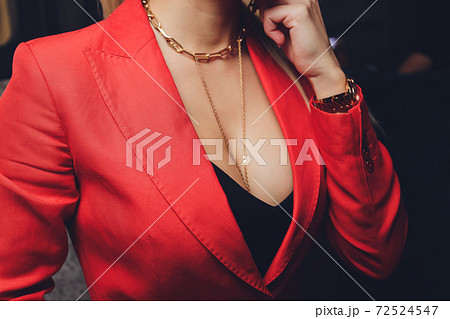 Woman in a red jacket revealing a black bra. Woman in a red jacket revealing a black bra. 72524547