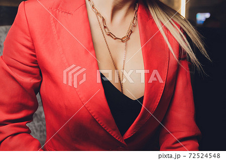 Woman in a red jacket revealing a black bra. Woman in a red jacket revealing a black bra. 72524548