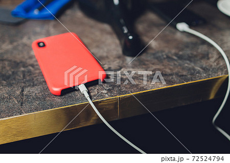 Charging Smartphone With Grey Portable External Battery powerbank on Wooden Table . Charging Smartphone With Grey Portable External Battery powerbank on Wooden Table . 72524794