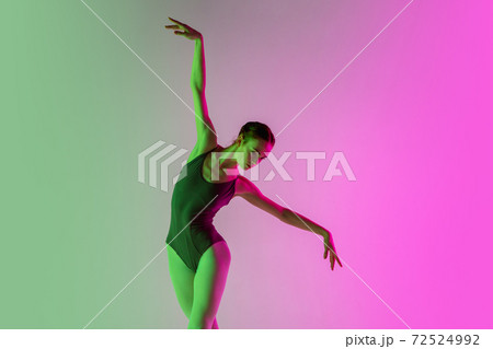Young and graceful ballet dancer isolated on gradient pink-green studio background in neon light. Art in motion Young and graceful ballet dancer isolated on gradient pink-green studio background in neon light. Art in motion 72524992