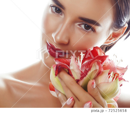 young pretty brunette real woman with red flower amaryllis close up isolated on white background. Fancy fashion makeup, bright lipstick, creative Ombre manicured nails young pretty brunette real woman with red flower amaryllis close up isolated on white background. Fancy fashion makeup, bright lipstick, creative Ombre manicured nails 72525658