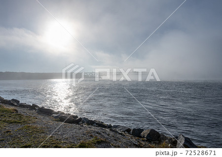 A bridge in fog. Blue ocean and mist in the background. Picture from the bridge connecting Sweden with Denmark 72528671