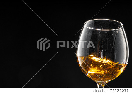 Glass of wine on black background, close up Glass of wine on black background, close up 72529037