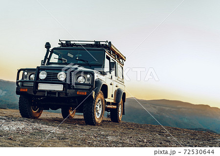 Dark green off-road car in the mountains Dark green off-road car in the mountains 72530644