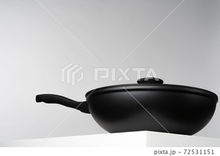 New black frying pan against grey background 72531151