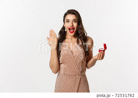Image of excited woman showing her wedding ring on finger and looking happy, say yes to marriage proposal, being engaged Image of excited woman showing her wedding ring on finger and looking happy, say yes to marriage proposal, being engaged 72531762